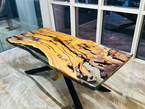 Hackberry Flow wood and clear epoxy office table with live edges and a black metal base at MENA Capital in Dubai.