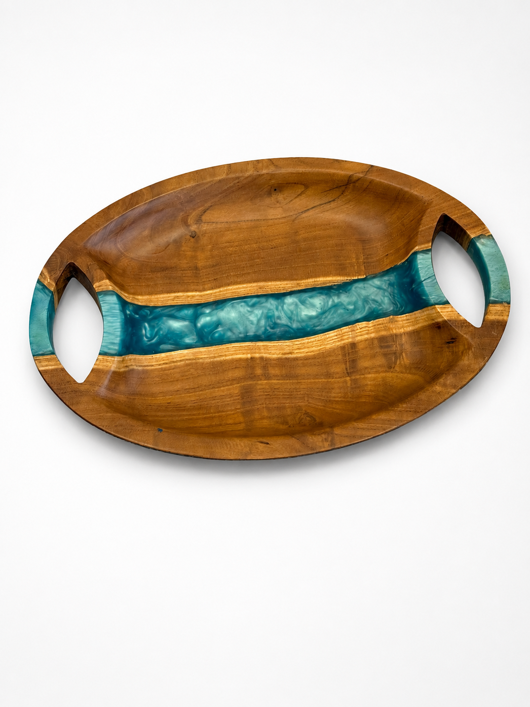 Oval walnut serving tray with a river-blue pearl epoxy band running across the centre and two carved oval handles, handmade in Dubai.