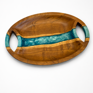 Oval walnut serving tray with a river-blue pearl epoxy band running across the centre and two carved oval handles, handmade in Dubai.